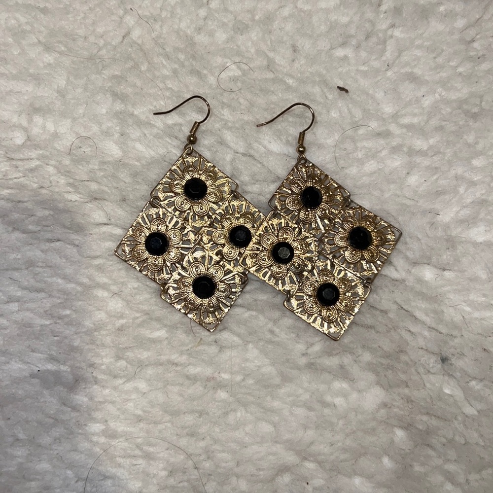 Gold flower costume earrings with black centers